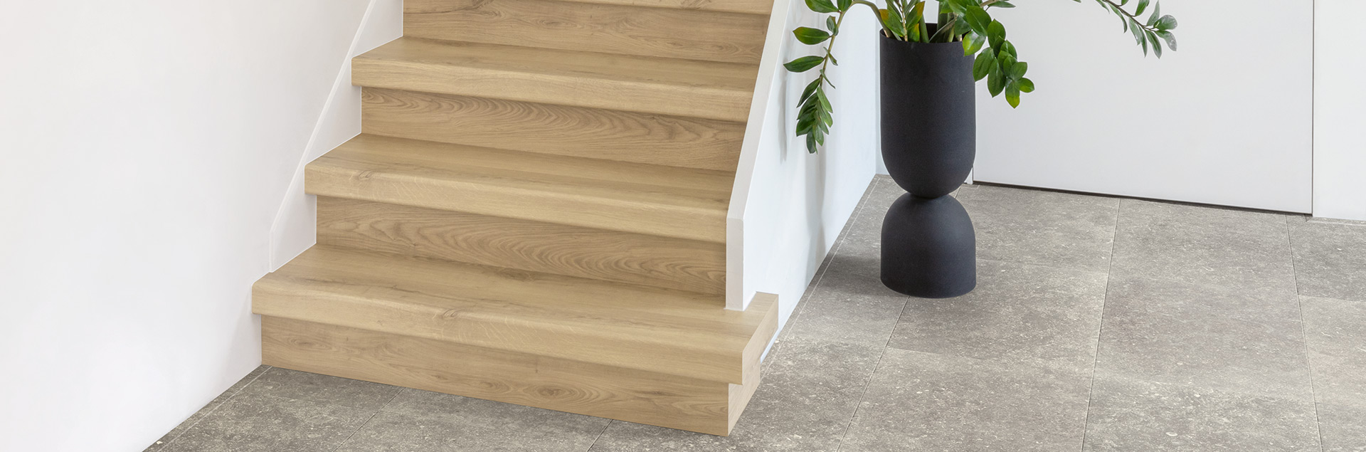 Beige laminate stairs with stair covers in white hall
